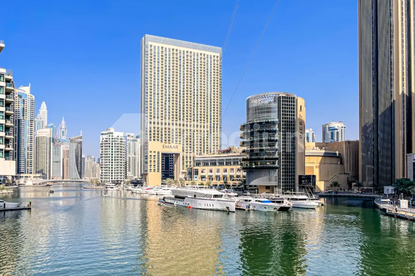 A large rectangular tower overlooking a marina