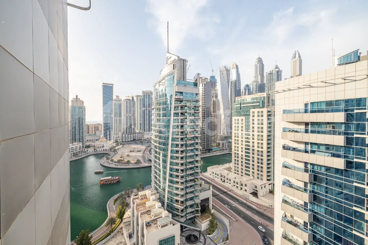 A view of a tall sleek tower next to a canal