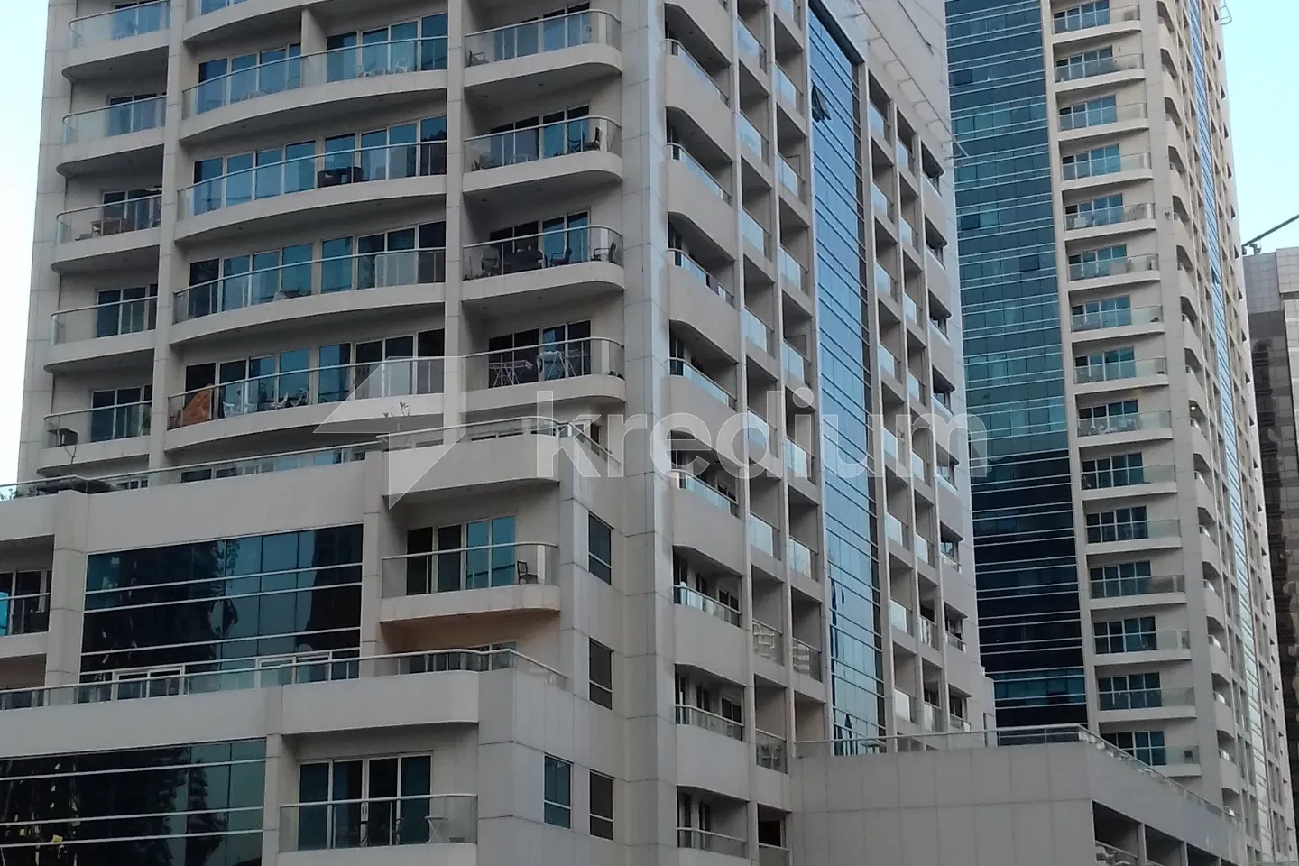 Modern residential tower with glass balconies