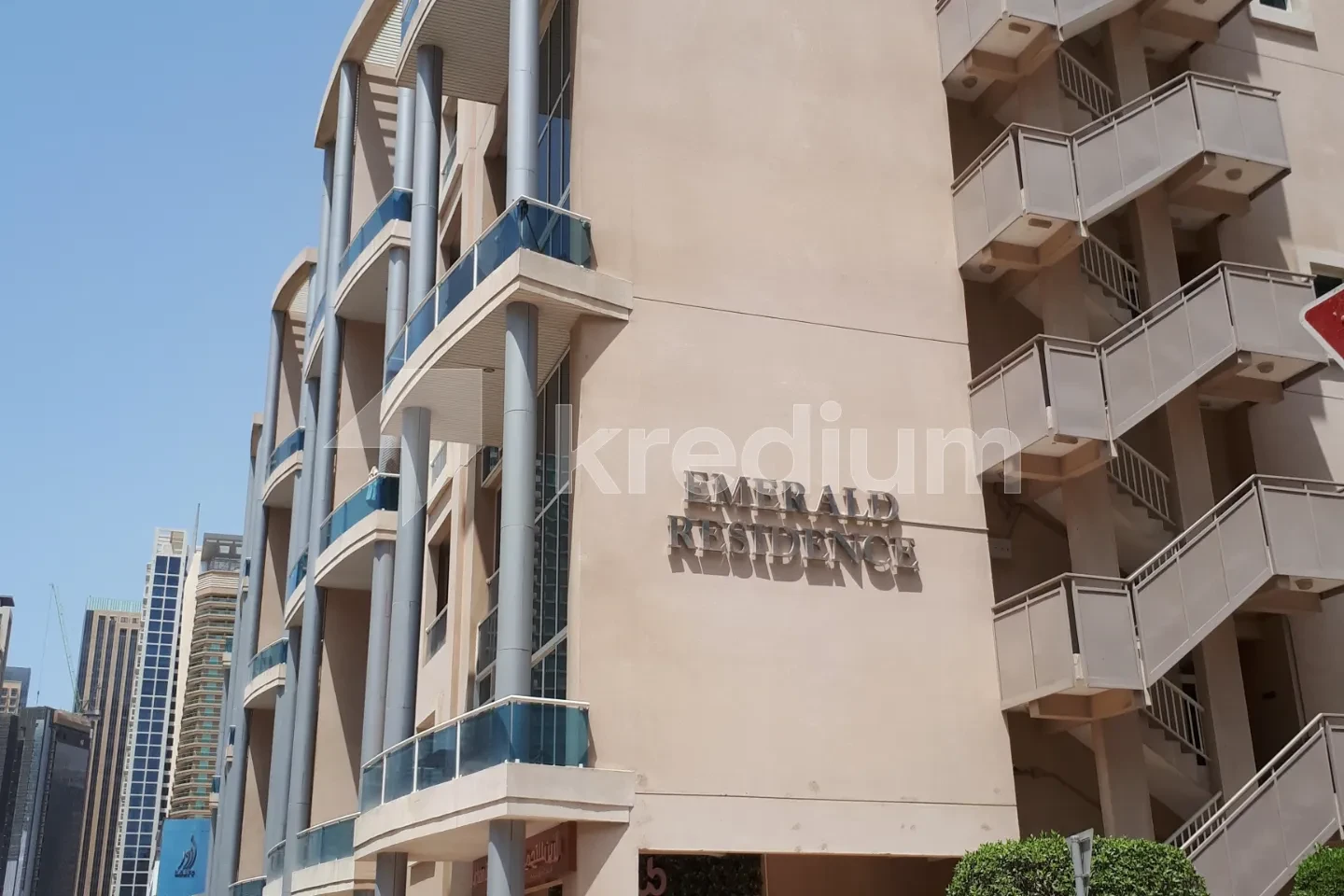 Mid-rise residential building with an Emerald residence sign on the side
