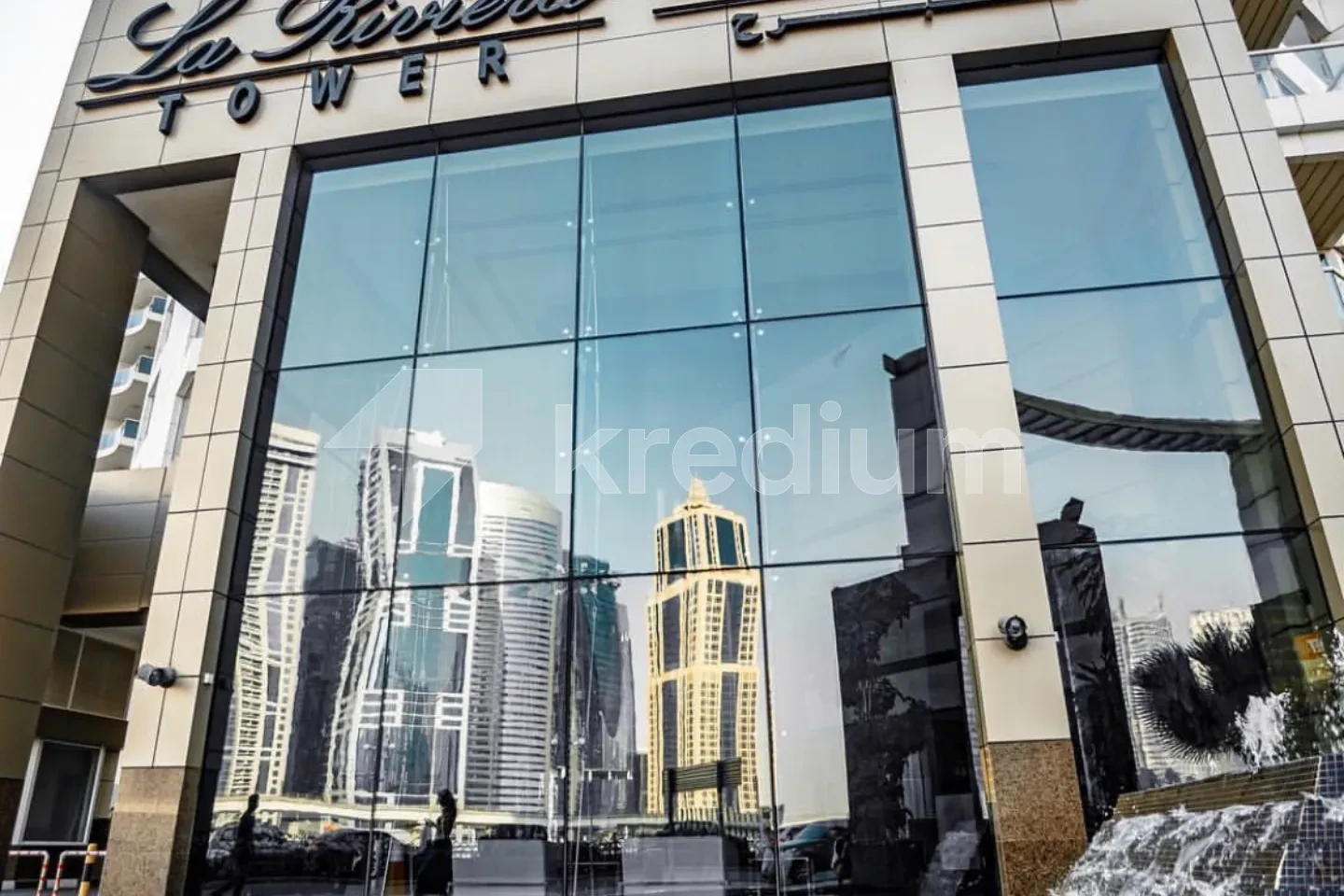 Emtrance to a modern building with a La riviera tower sign above