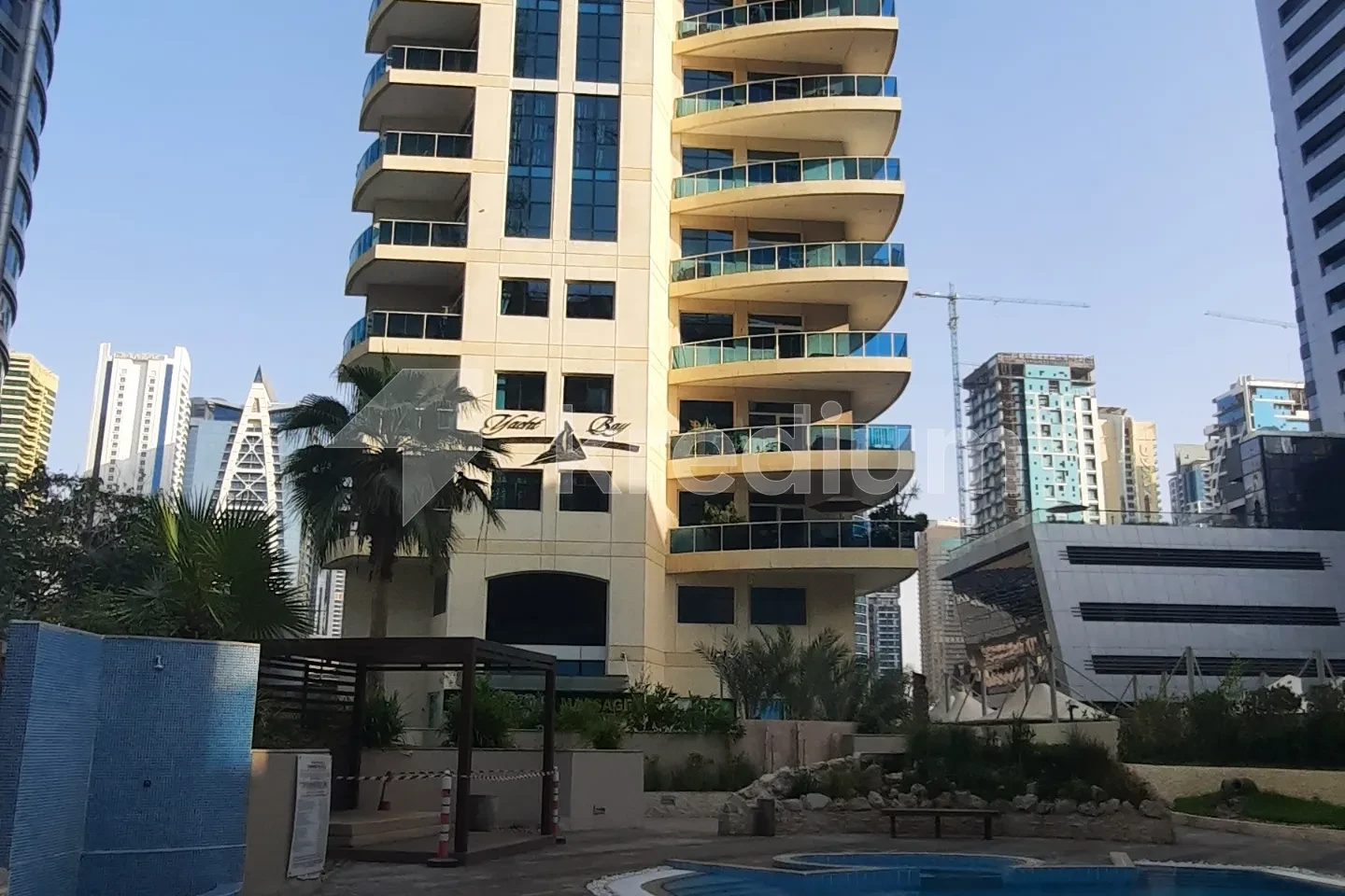 A modern building overlooking an outdoor swimming pool