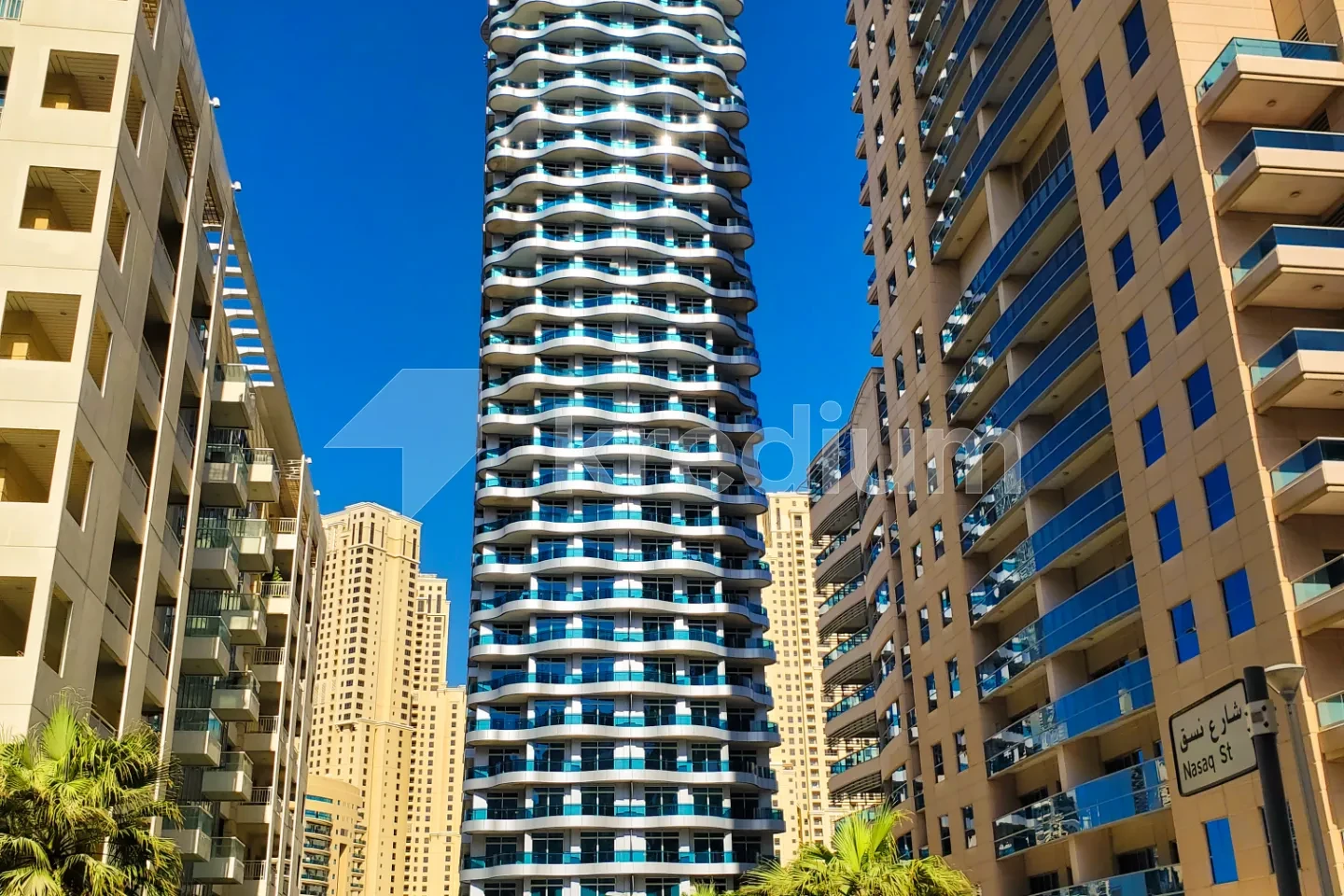 A modern glass and steel residential high-rise building