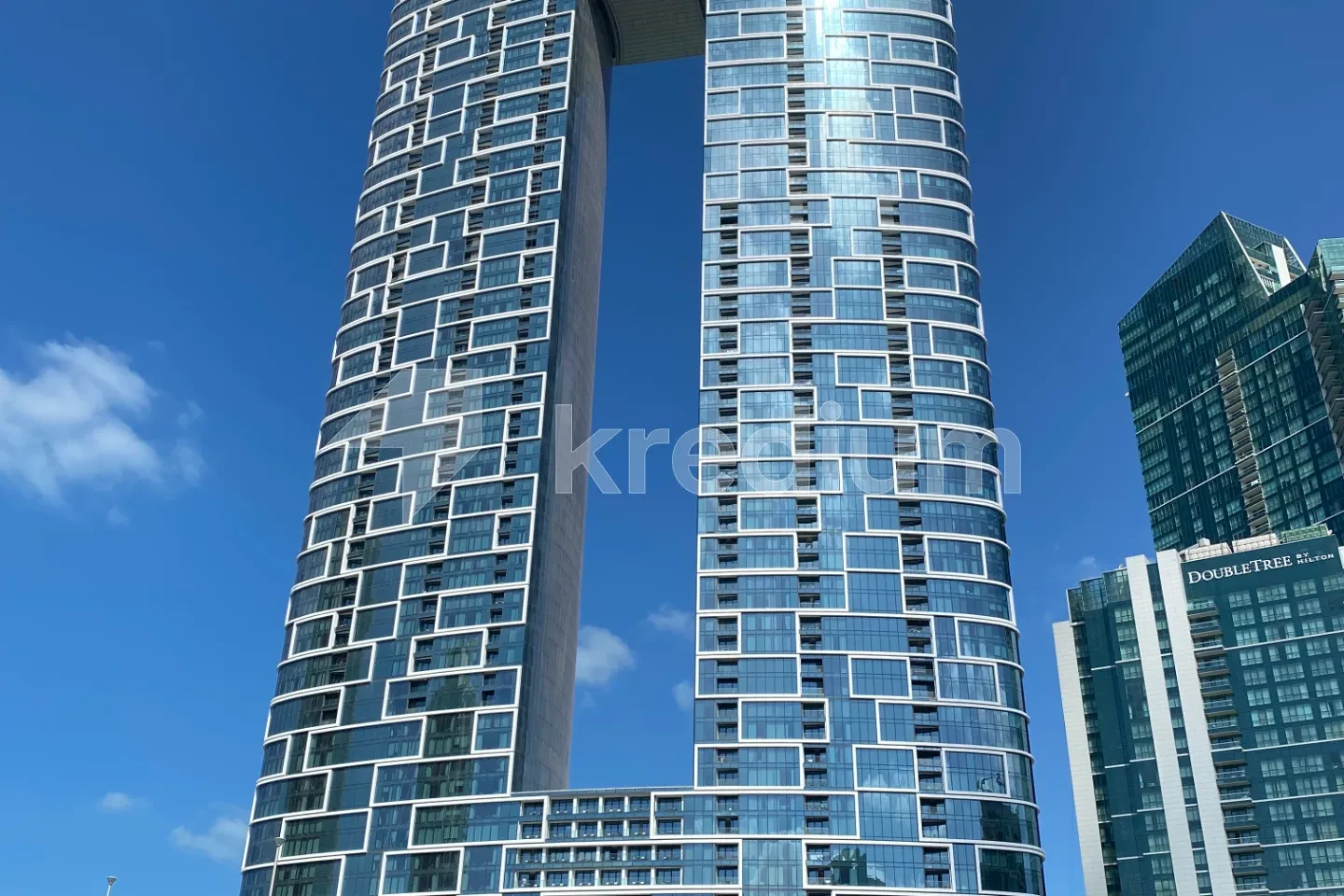 Two stylish glass towers connected by at the bottom and the top