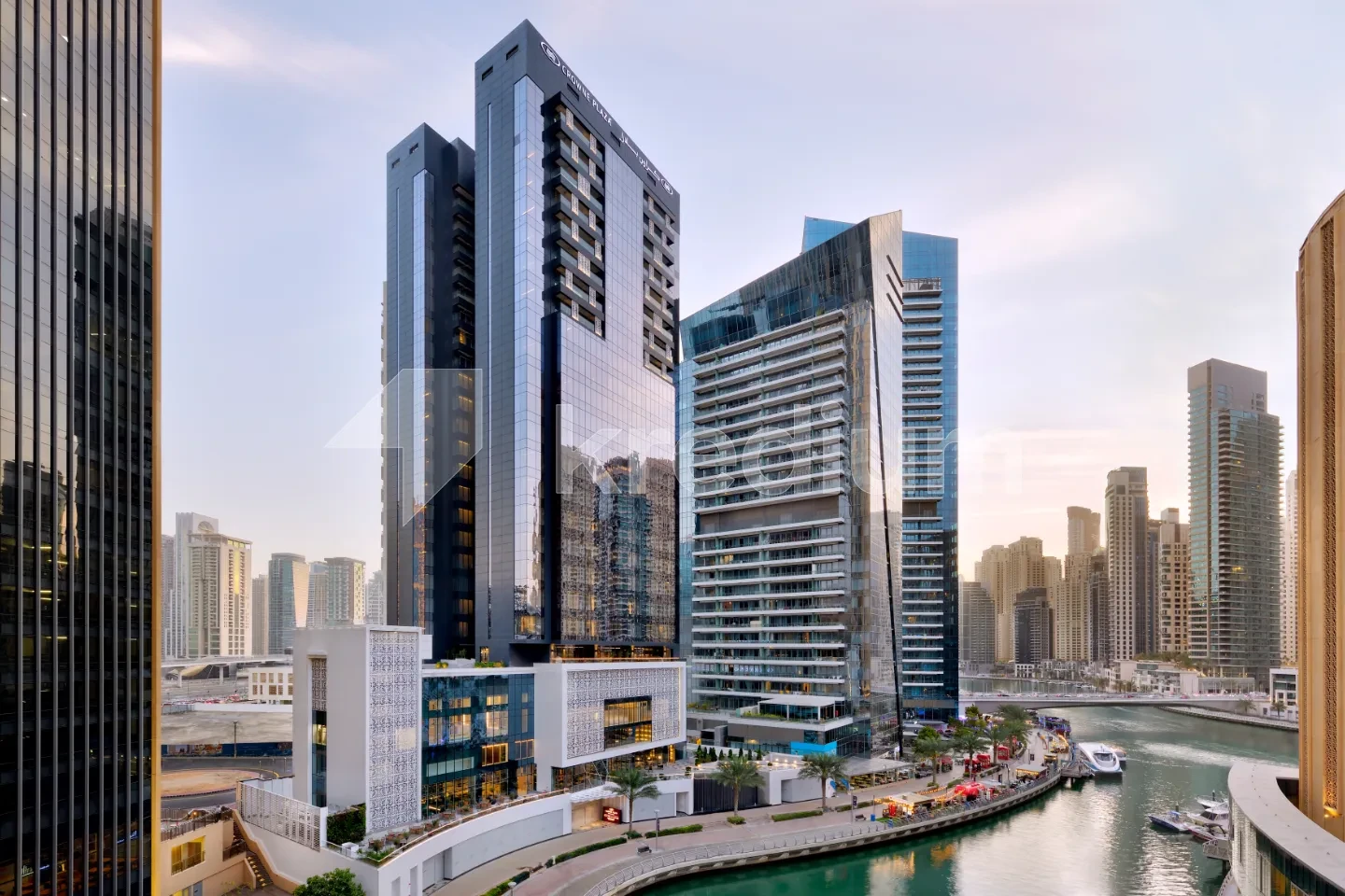 Upscale glass tower in a modern neighborhood overlooking a canal