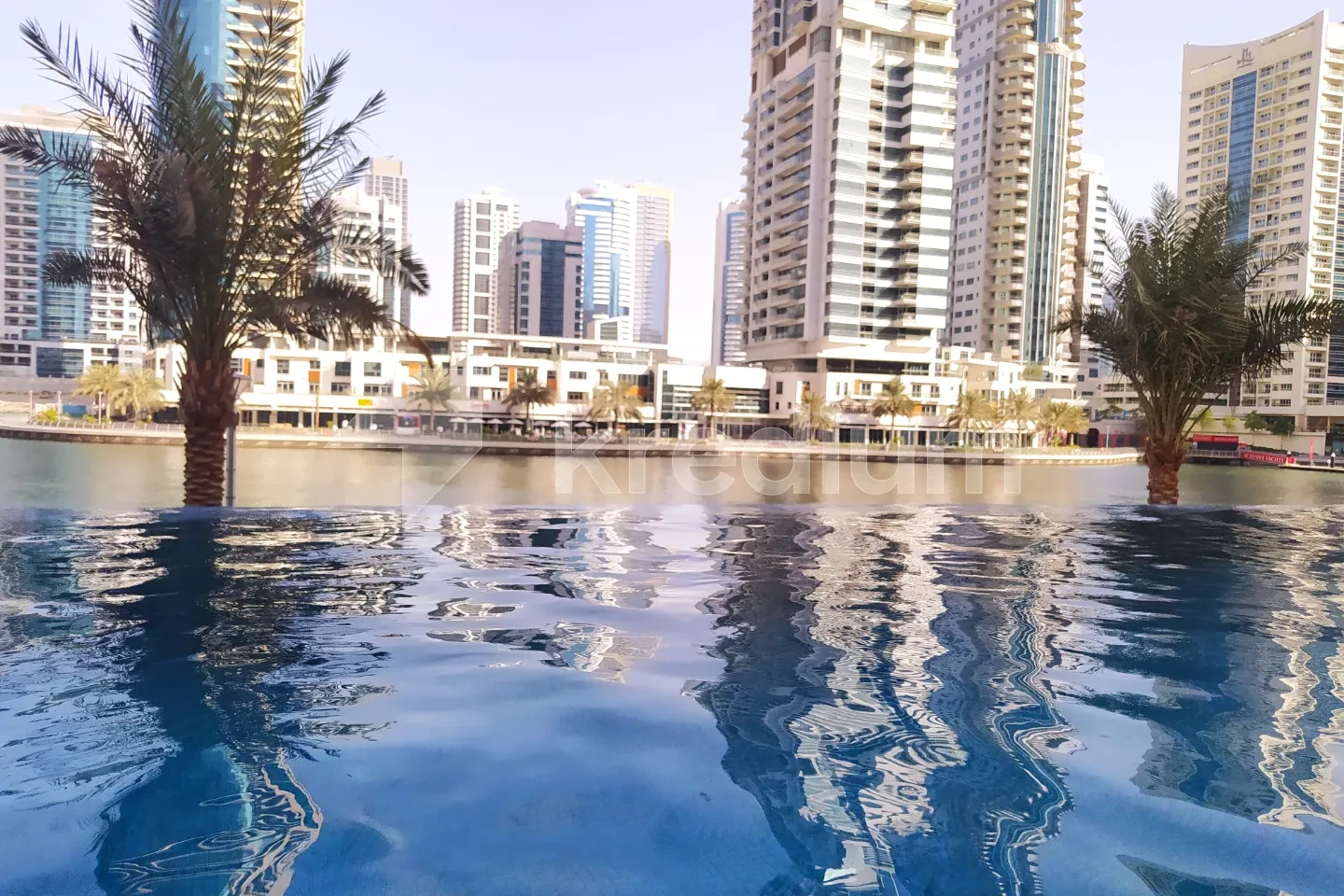 A swimming pool with high-rise buildings in the background