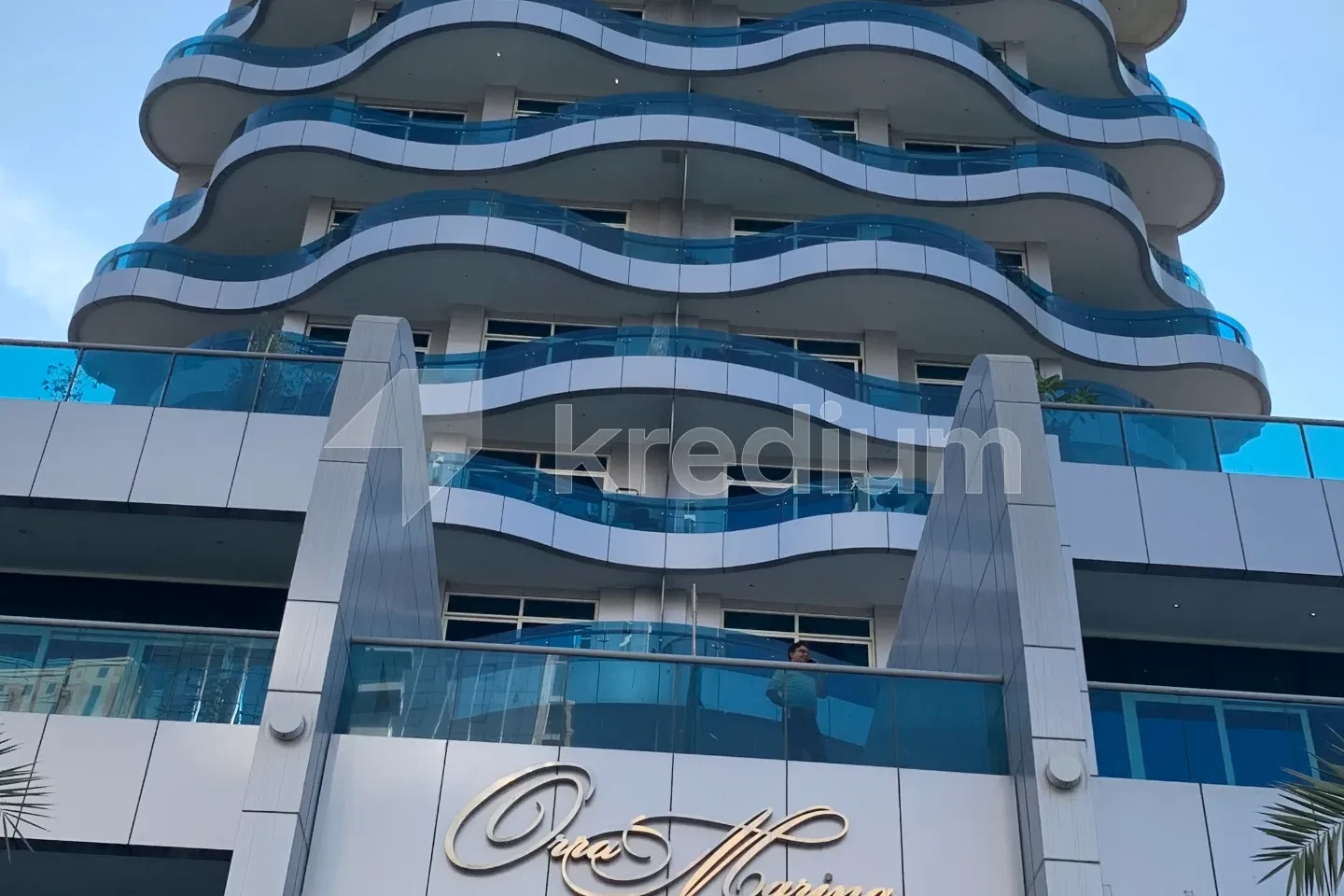 A glass building with wavey balconies