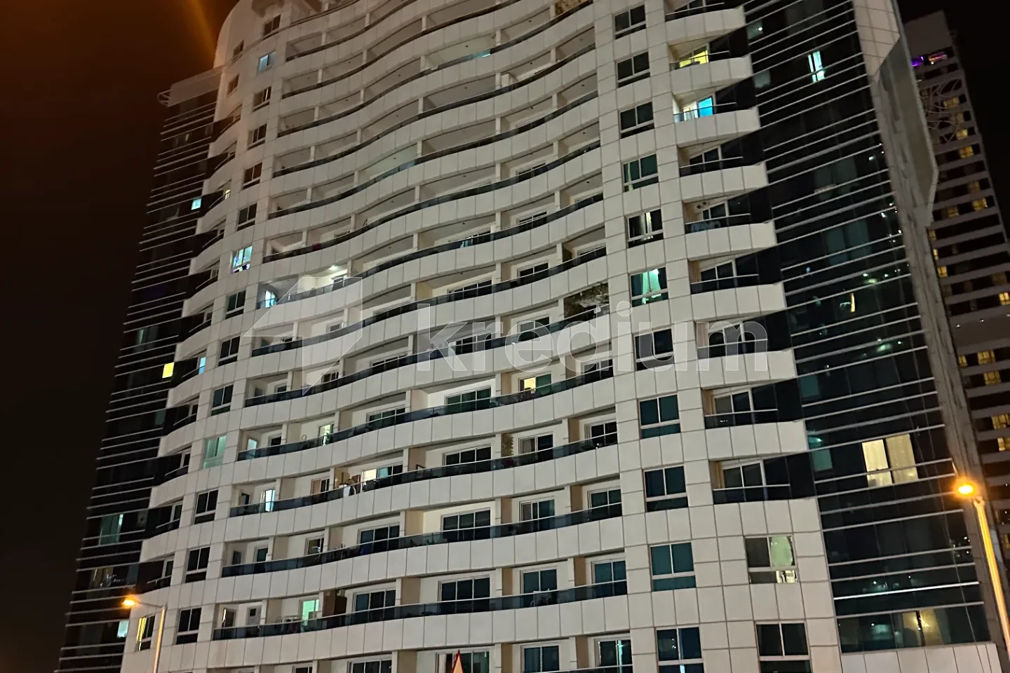 Night image of a modern residential high-rise building