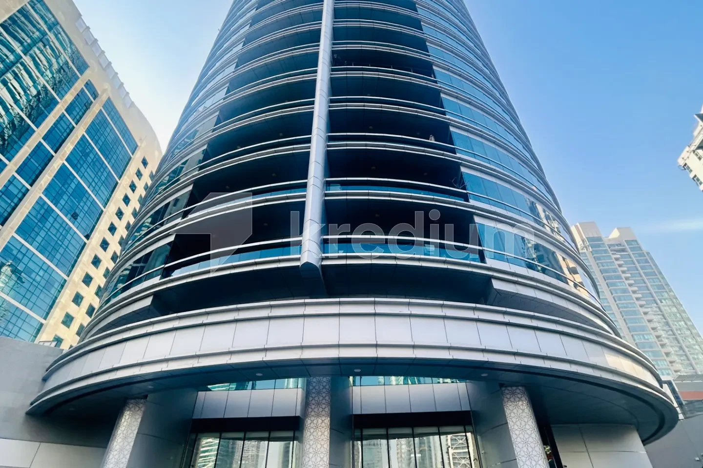 A look of a sleek round glass tower