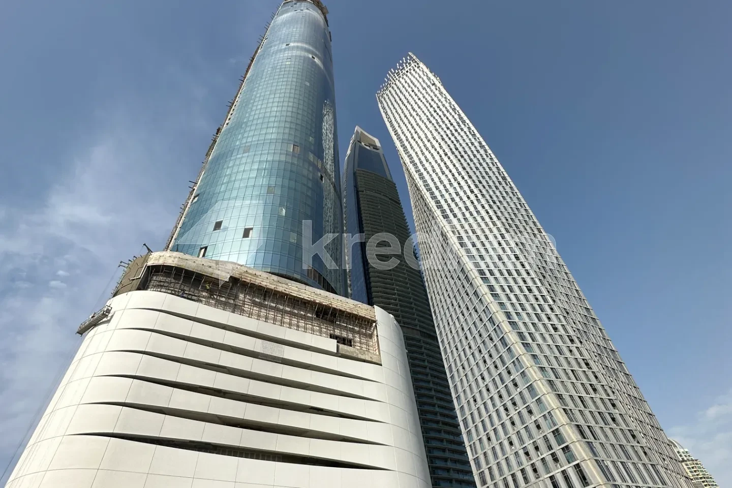 A view of modern skyscrapers against a clear blue sky