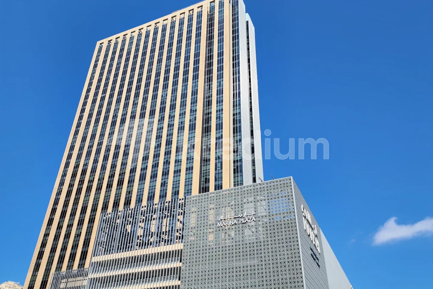 A modern skyscraper with blue skies in the background