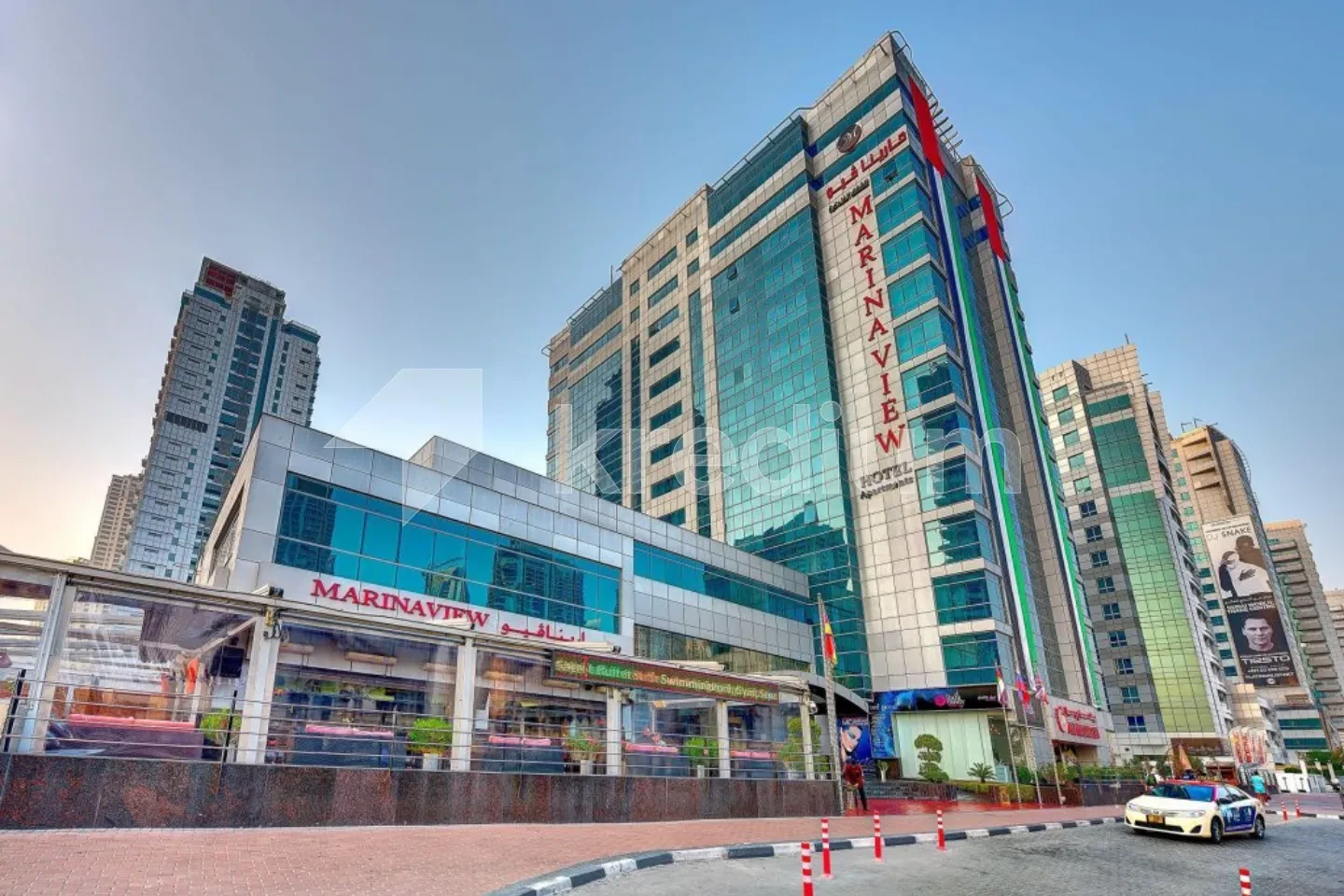 A modern commercial and residential building with a Marina View sign