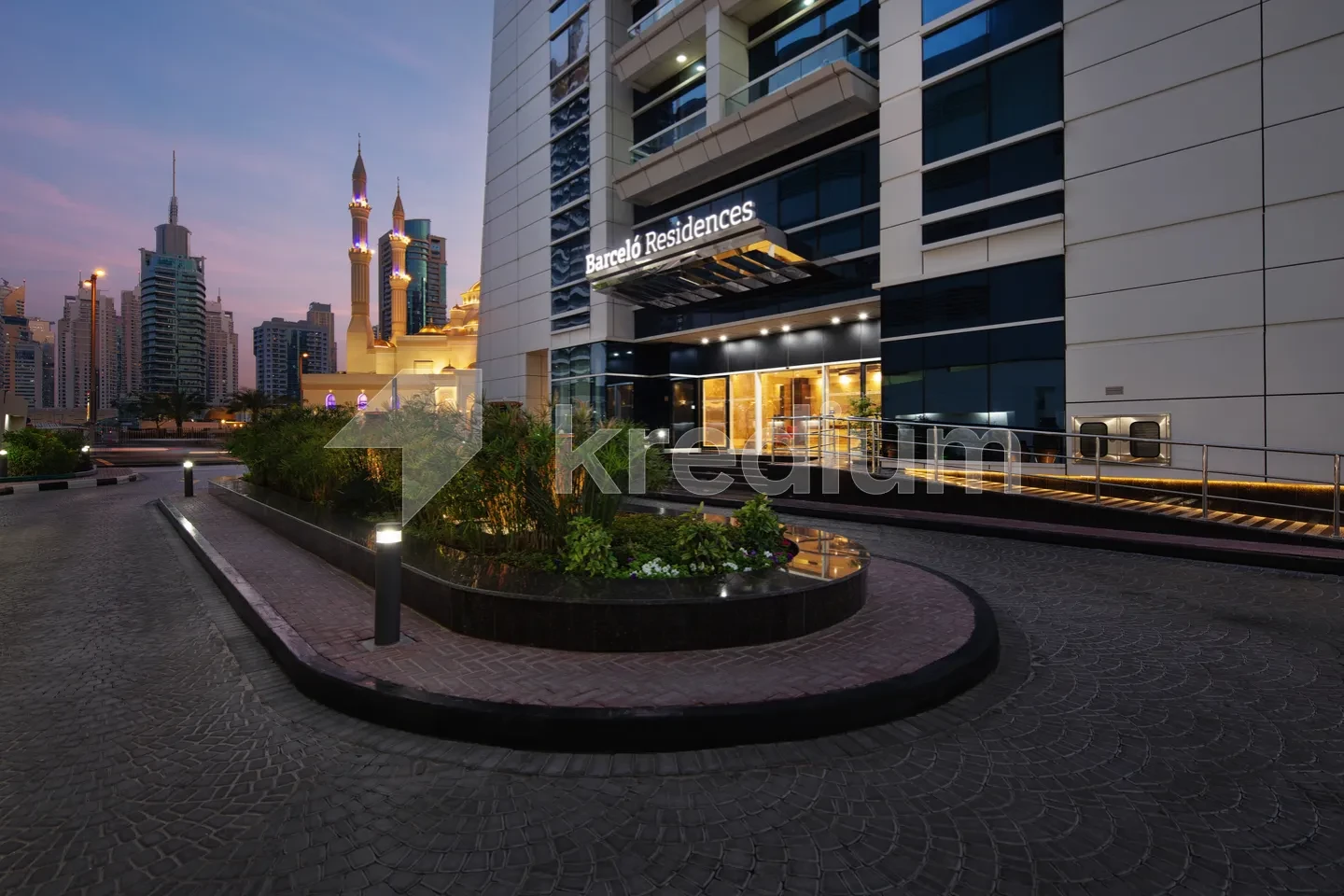 Entrance to a luxury building with Barcelo Residences sign above the door