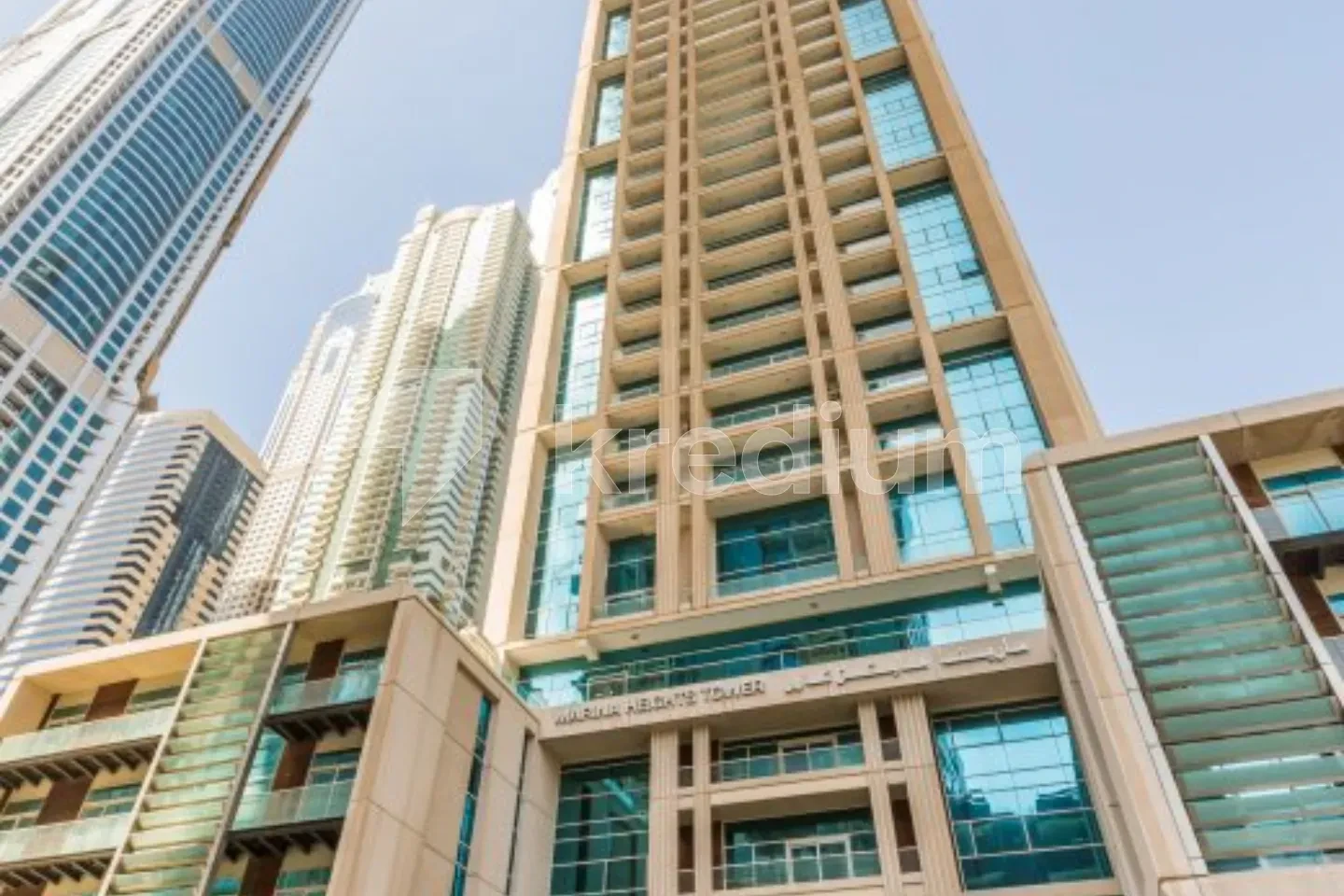 A tall elegant tower in an urban neighborhood