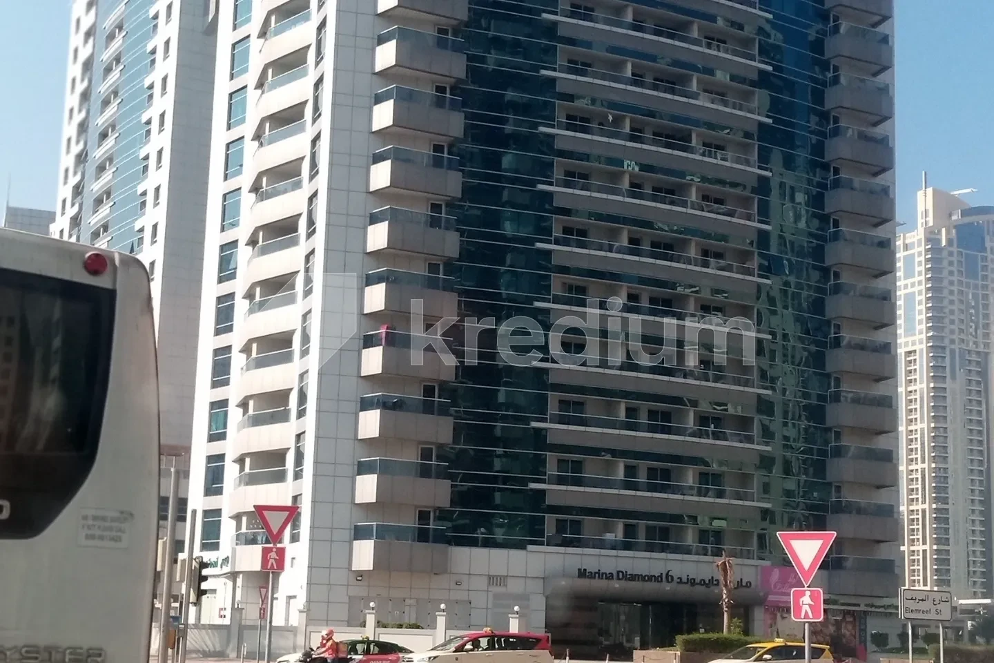 An elegant high-rise building with Marina Diamond 5 sign above the entrance