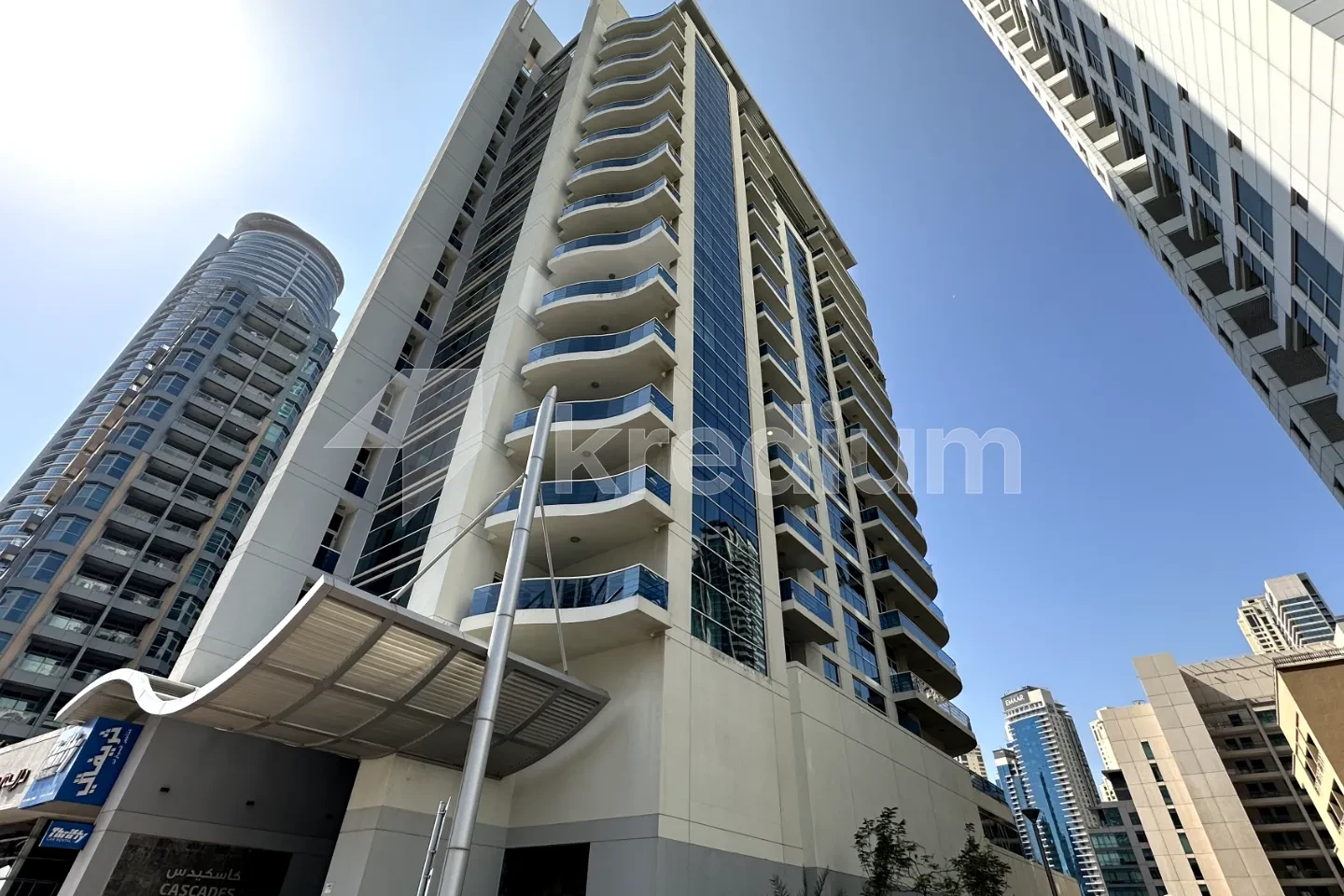 A modern residential building with glass balconies