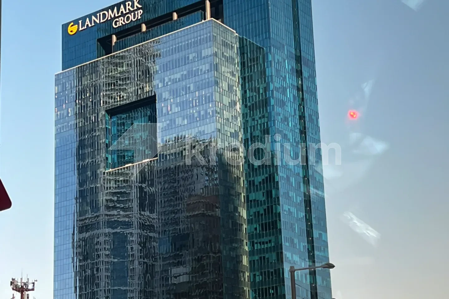 Elegant glass tower with a Landmark group sign