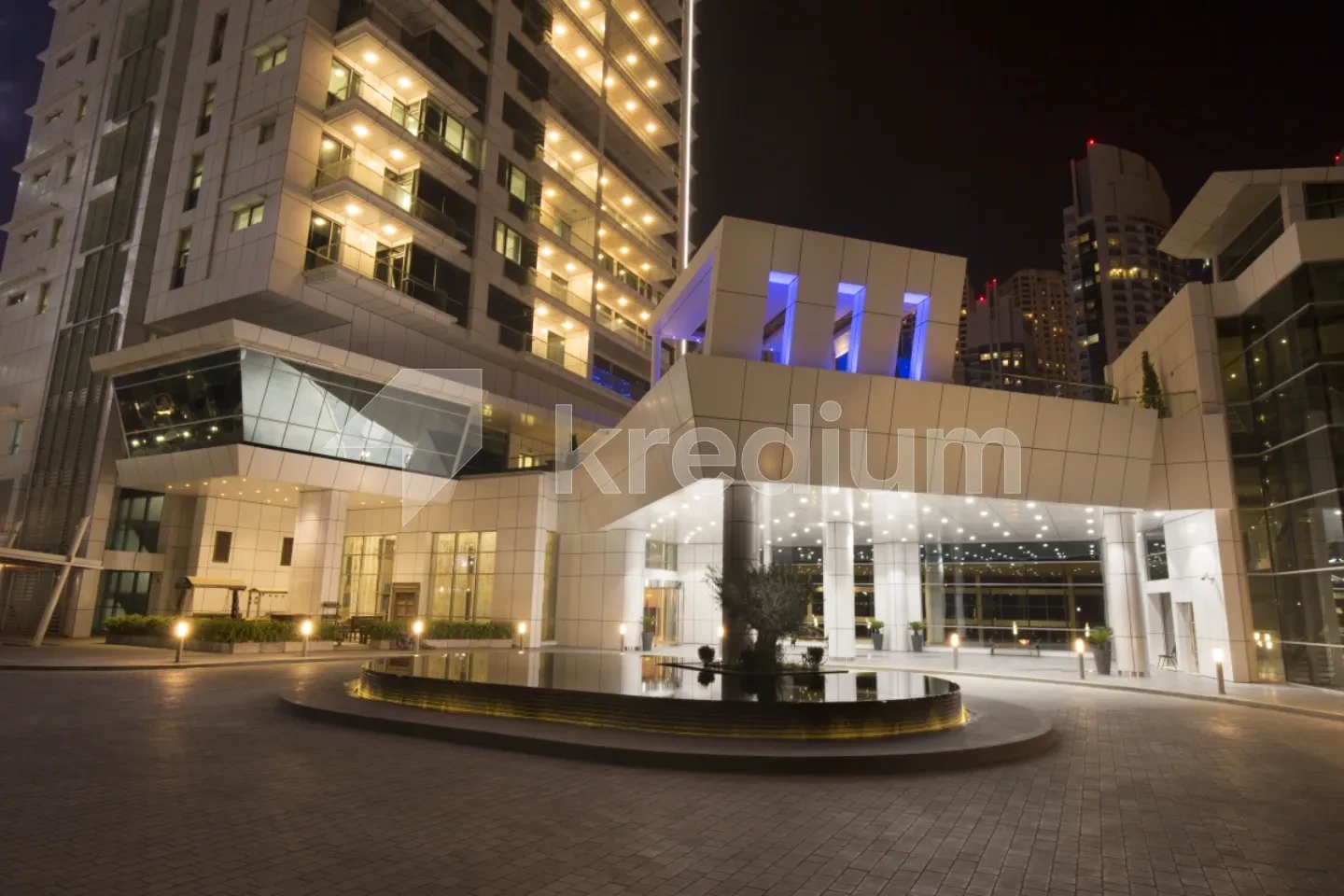 Night image of an entrance to a sleek building