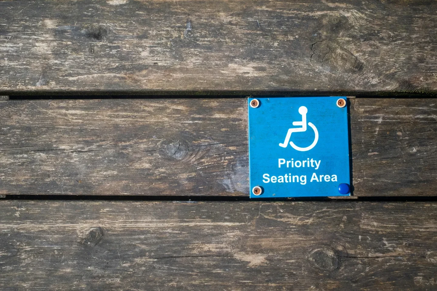 A blue priority seating area sign.
