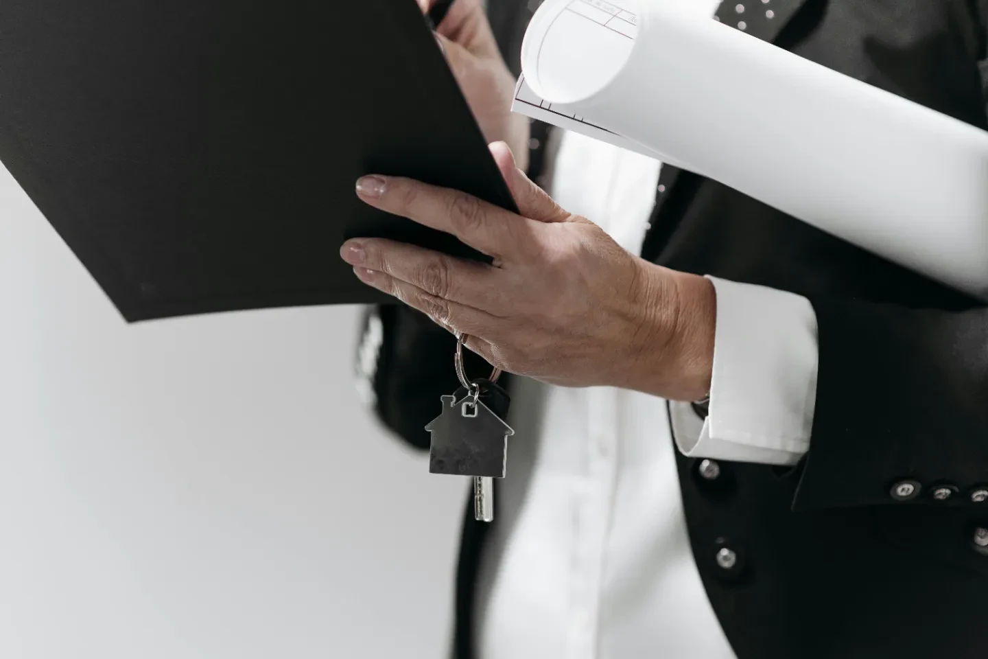 A woman holding the keys and writing on the document.