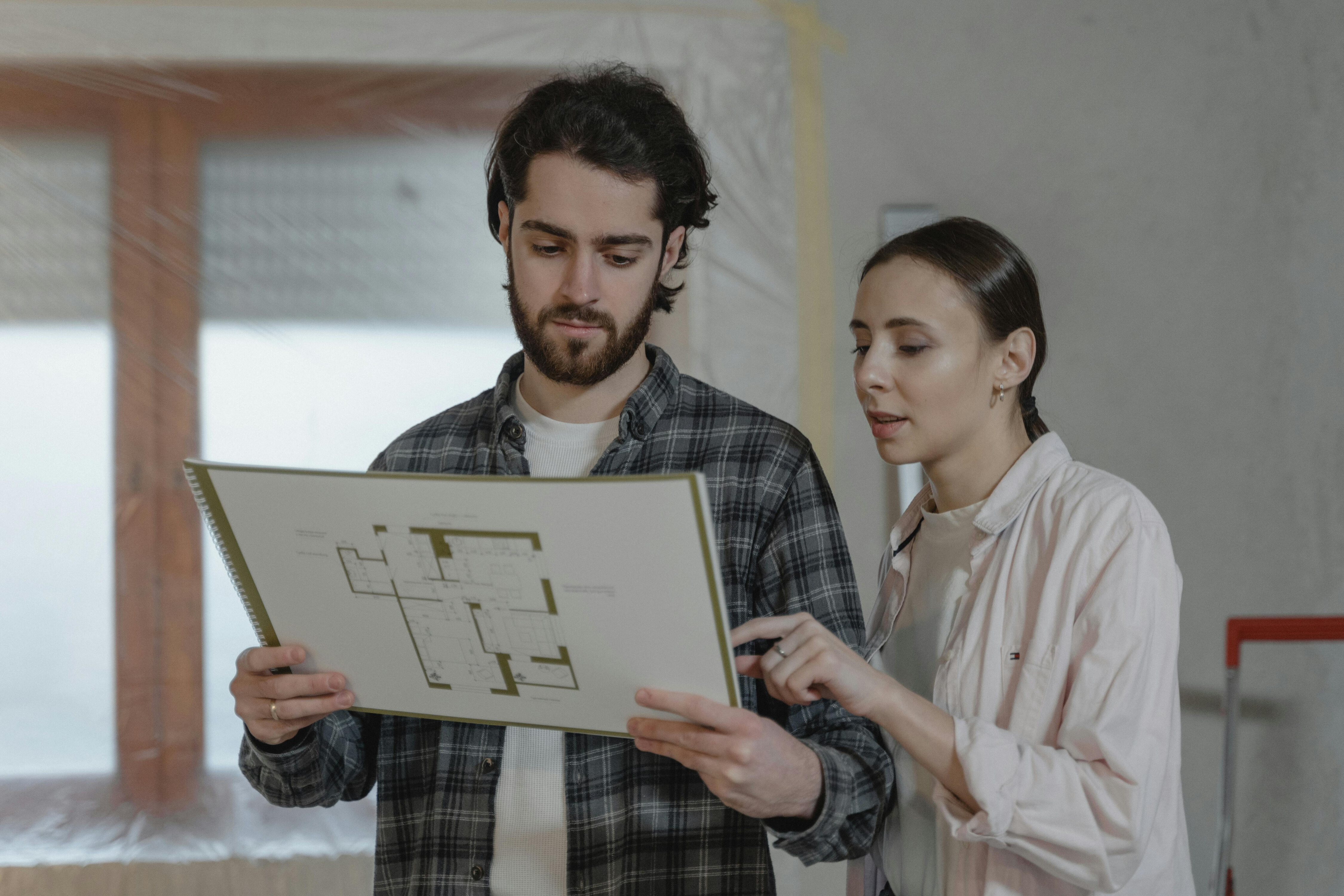 A couple looking at the floor plan document.