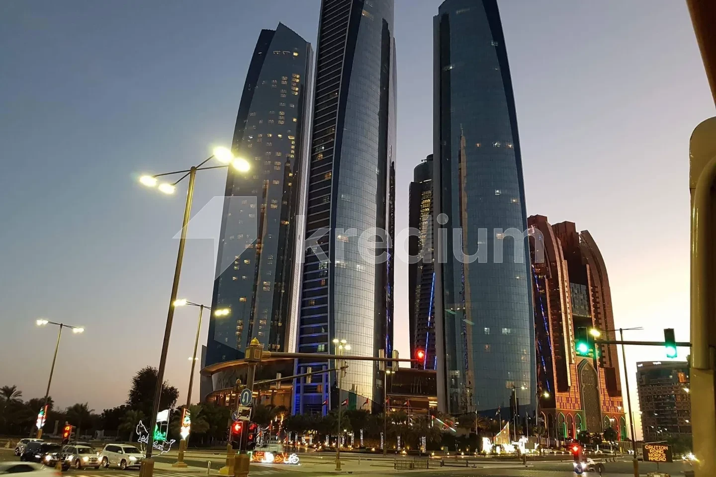 Three stylish glass skyscrapers next to a busy street