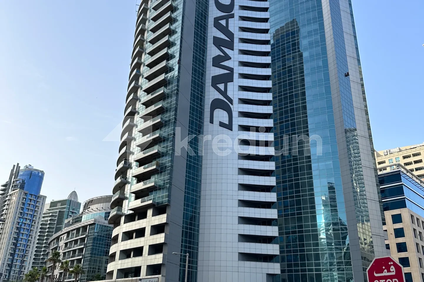 a glass tower with the damac logo on it